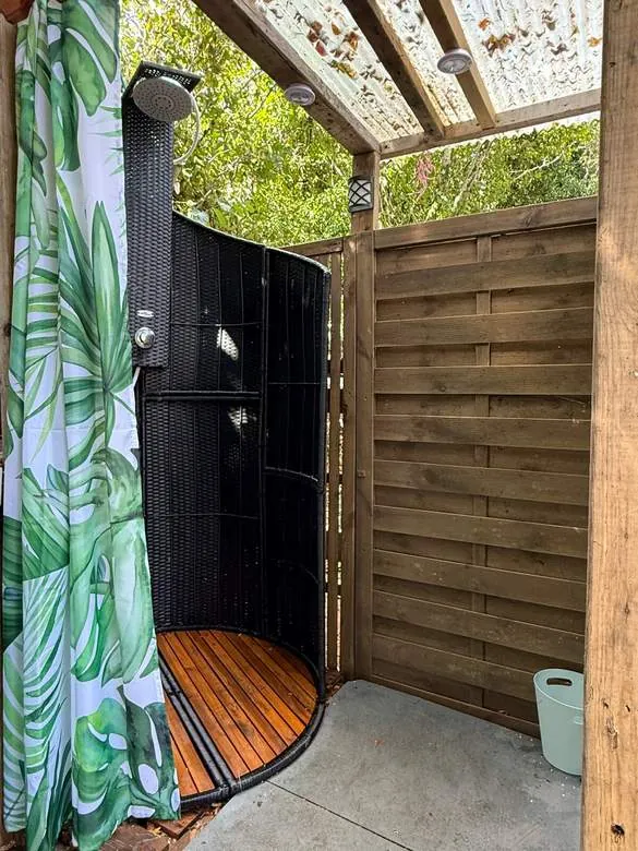 The hot outdoor shower among the trees